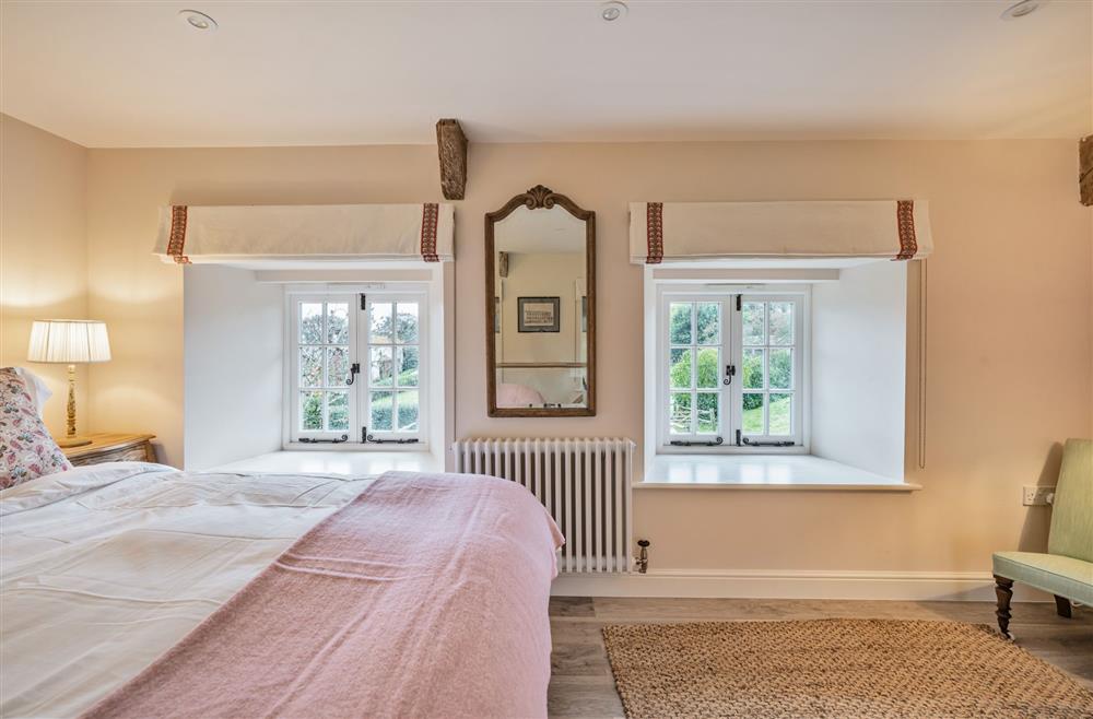 The bedroom with a king-size bed (photo 3) at Piddle Cottage, Dorchester