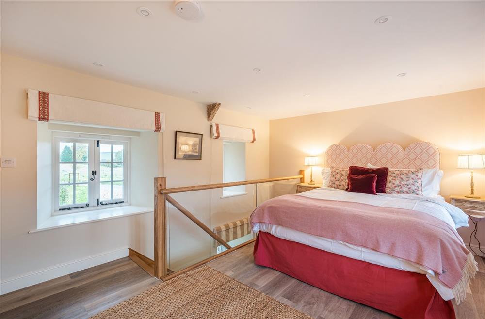 The bedroom with a king-size bed at Piddle Cottage, Dorchester
