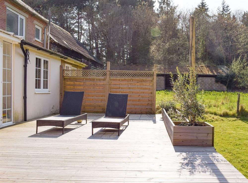 Spacious decked area overlooking garden at Pigeon Coo Farmhouse in Hamstead, near Yarmouth, Isle of Wight