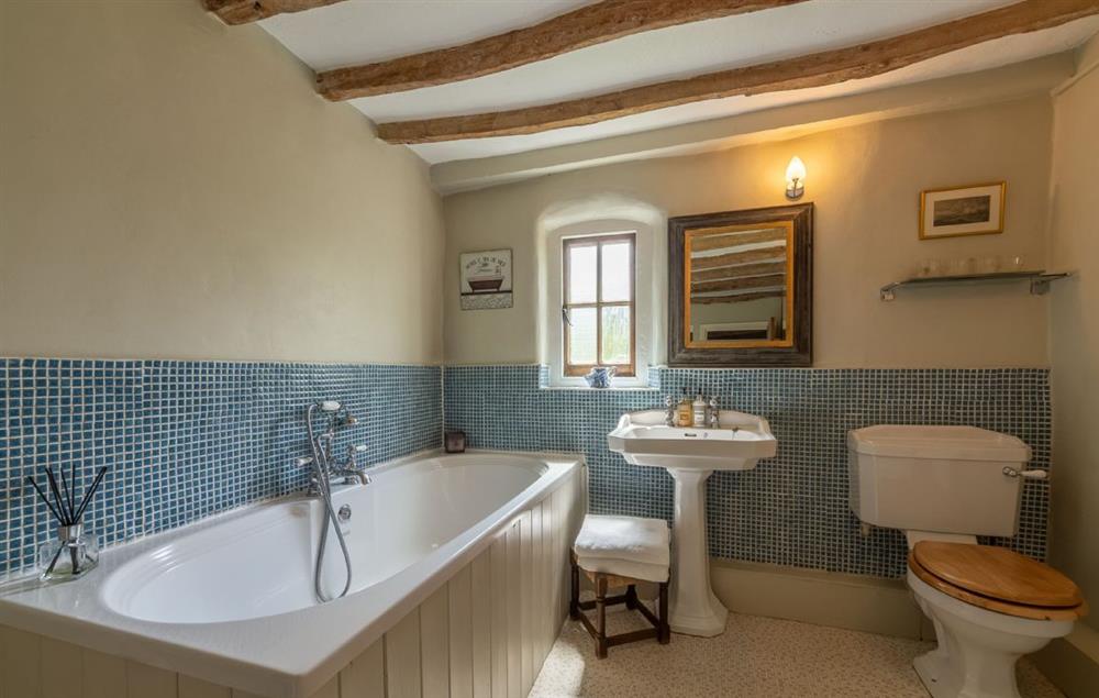 Family bathroom with bath and hand held shower attachment at Pillar Box House, Hackford