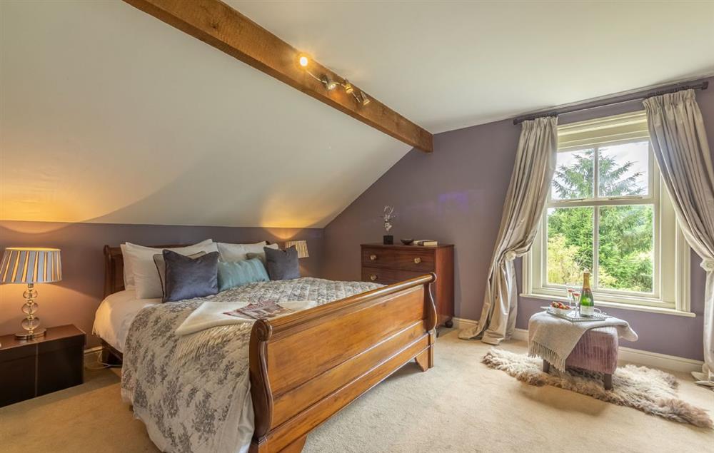Master bedroom with king size bed at Pillar Box House, Hackford