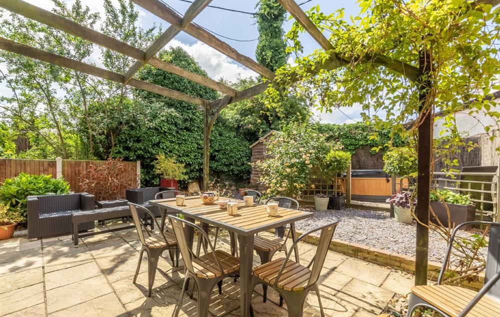 Private enclosed garden and patio with hot tub at Pillar Box House, Hackford