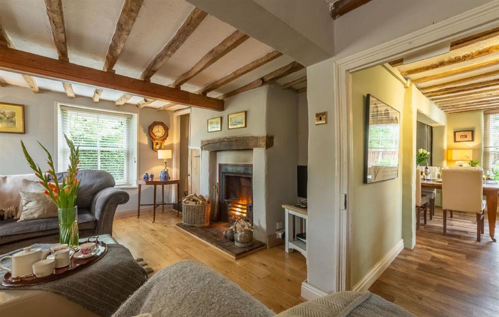 Sitting room with open fire at Pillar Box House, Hackford