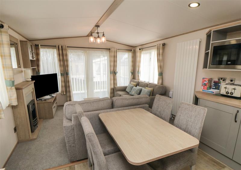 Relax in the living area at Pines 32, Cayton