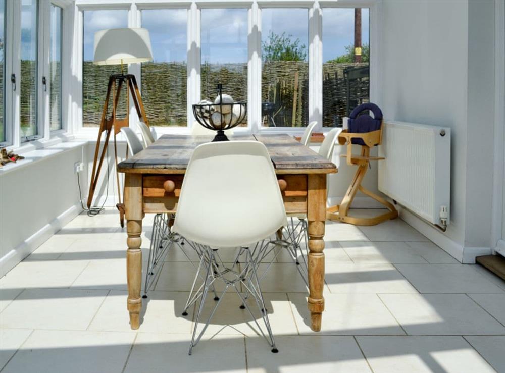 Conservatory with dining table at Pink Cottage in Egmere, near Wells-next-the-Sea, Norfolk