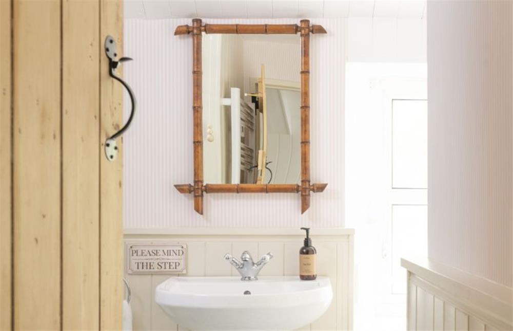 Bathroom with accent bamboo mirror at Pink Cottage, Penzance