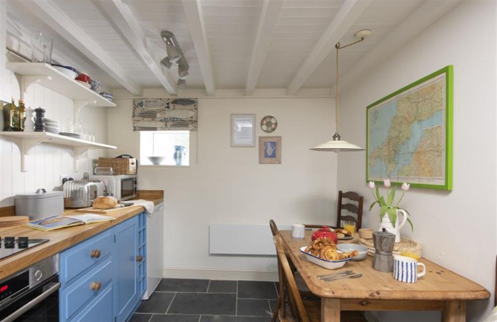 Kitchen with four ring hob, electric oven, fridge, dishwasher and washing machine at Pink Cottage, Penzance