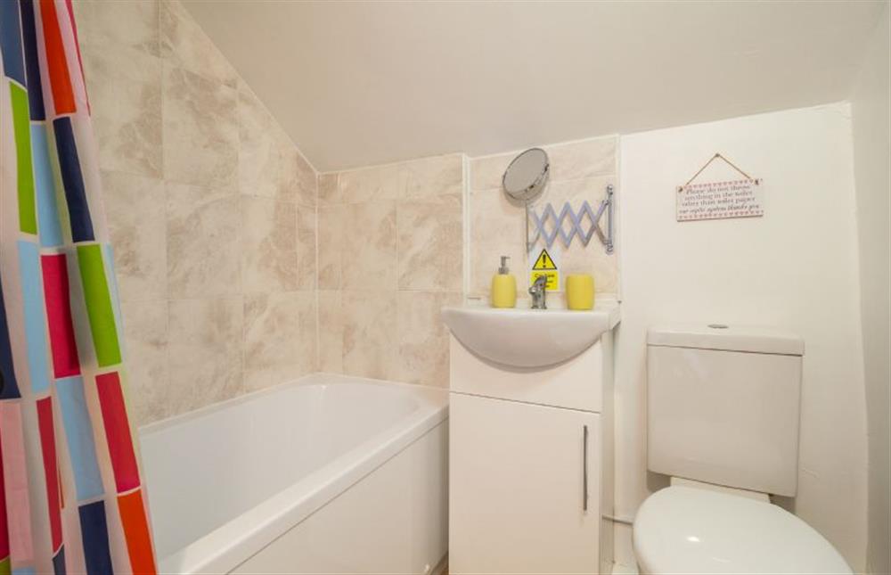 Family bathroom with bath with shower over, wash basin and WC at Pink Cottage, Stradbroke