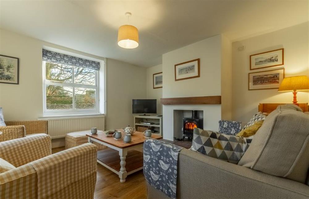 Ground floor: A pretty sitting room with wood burning stove at Pink End, North Creake near Fakenham