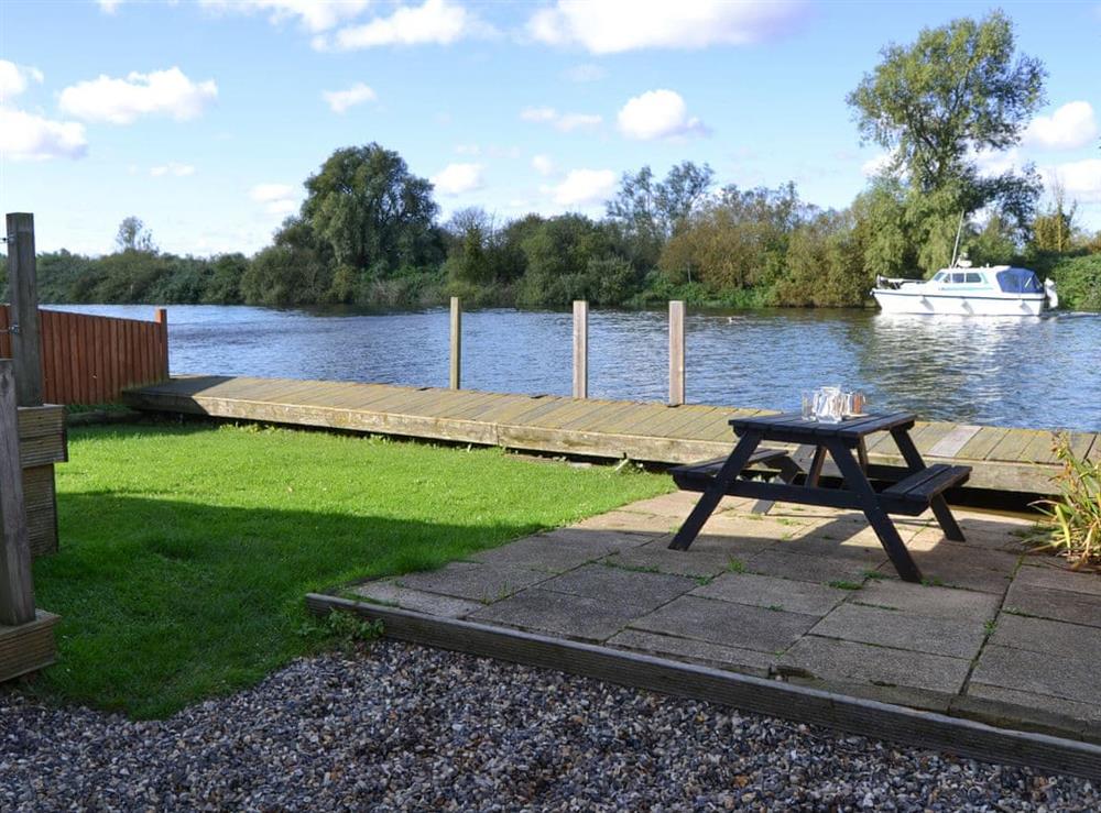Private riverside garden and patio area at Pintail in Brundall, near Norwich, Norfolk