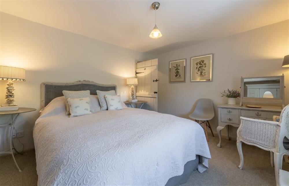 First floor: Master bedroom has king-size bed at Piper Cottage, Holme-next-the-Sea near Hunstanton