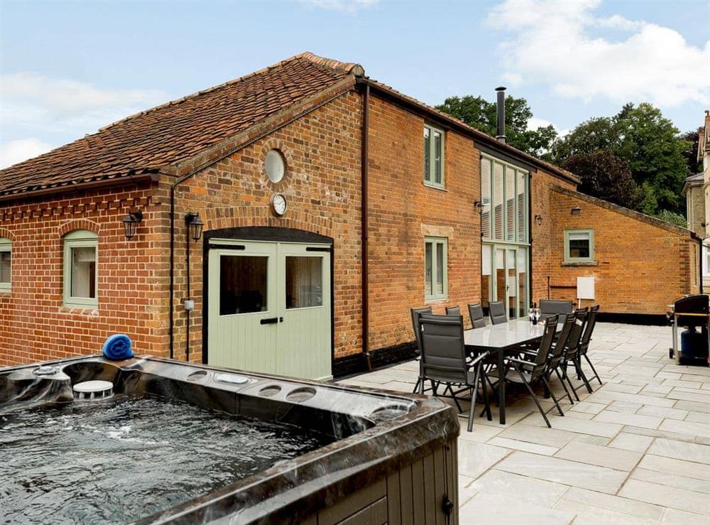 Impressive outdoor area with hot tub and BBQ at Pipistrelle Barn in North Walsham, Norfolk