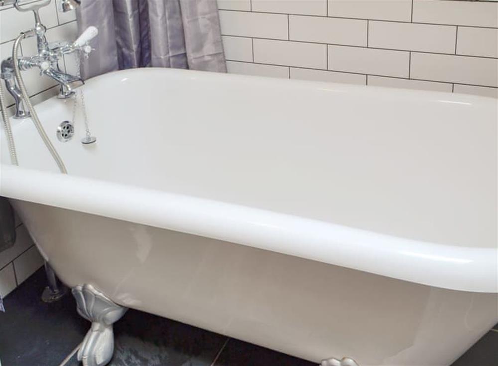Roll-top bath with shower within bathroom at Pipistrelle in Garth, near Builth Wells, Powys