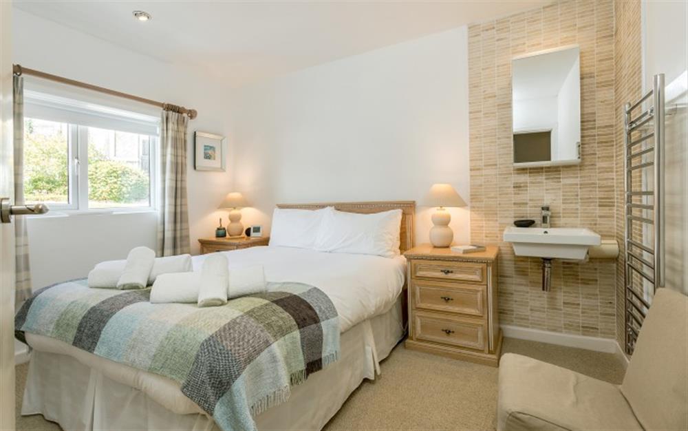 The modern master bedroom decorated in neutral tones. at Pirates Den in Helford Passage