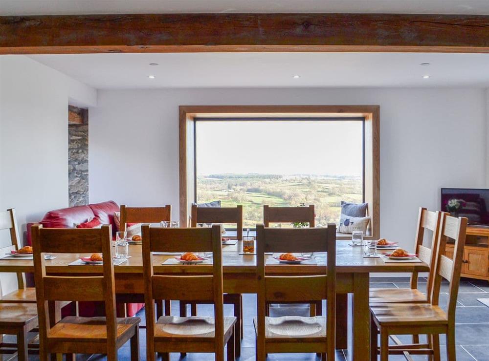 Large formal dining area with wonderful far-reaching views at Pistyll Gwyn in Llanwrthwl, near Rhayader, Powys