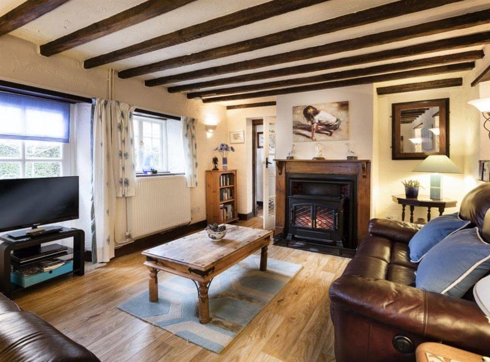 Charming beamed living room with open fire (photo 2) at Pitts Cottage in Brancaster, Norfolk., Great Britain