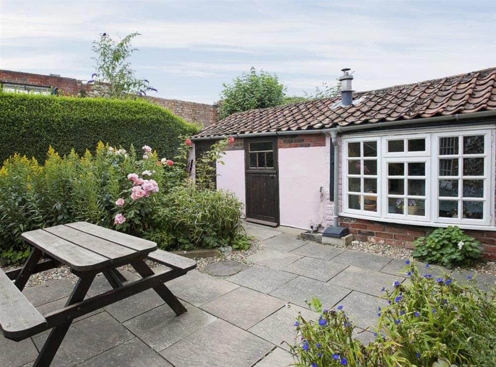 Peaceful garden with patio at Pitts Cottage in Brancaster, Norfolk., Great Britain