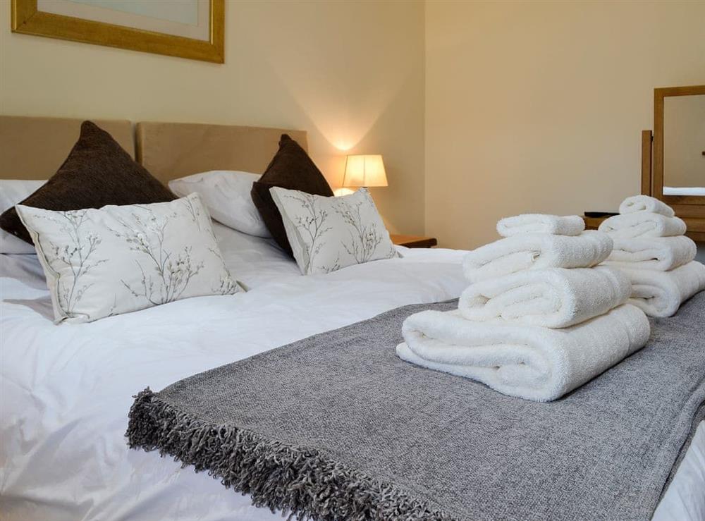 Bedroom configured as a double with super kingsize bed at Cruck Barn, 