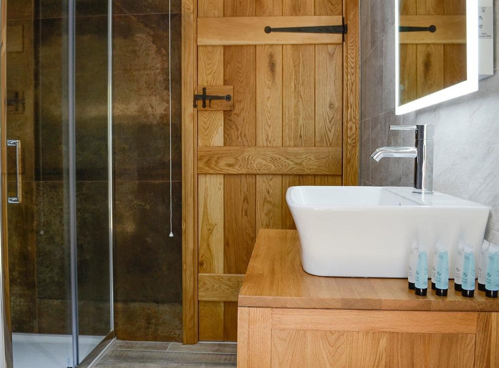 Contemporary wash basin and shower cubicle in the bathroom at Cruck Barn, 
