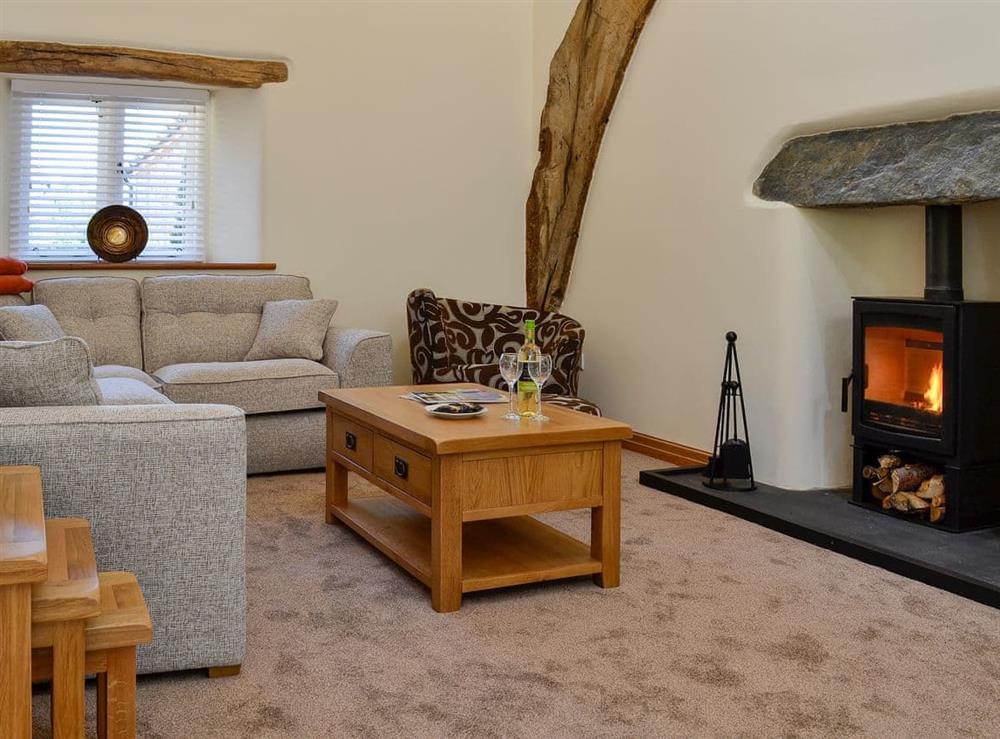 Cosy open plan living area at Cruck Barn, 