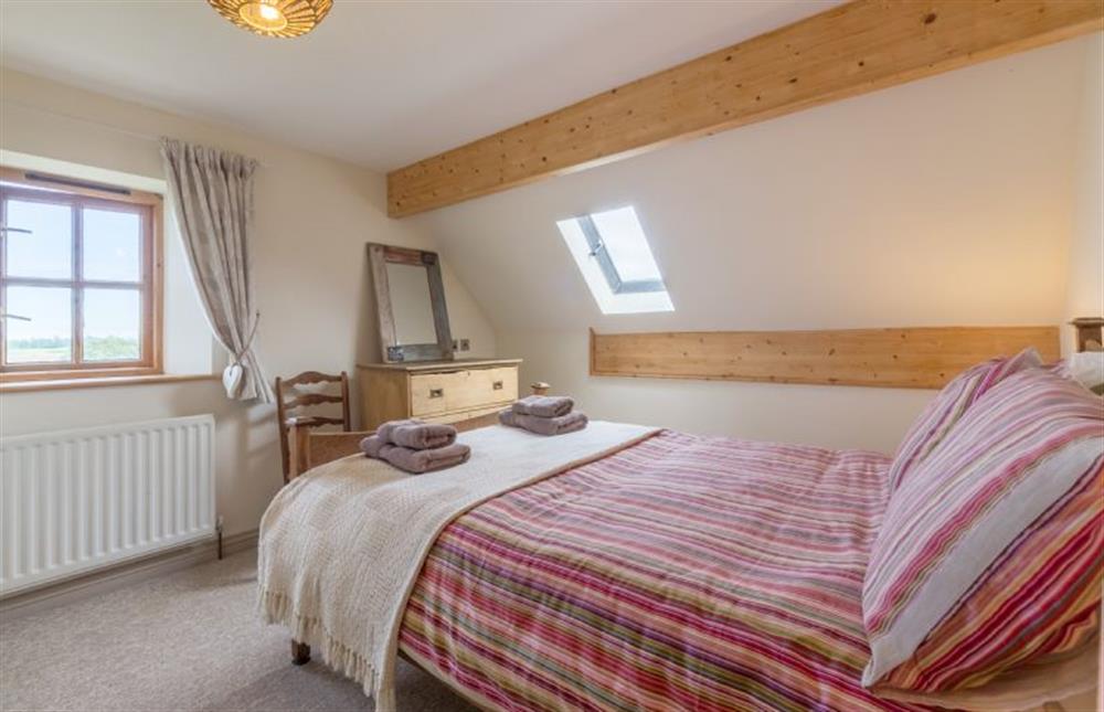 First floor: Bedroom three, double with great views at Plumtrees, Thornham near Hunstanton