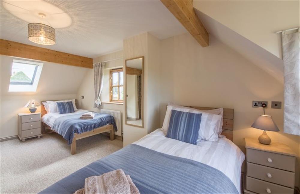 First floor: Bedroom two, twin room with triple aspect at Plumtrees, Thornham near Hunstanton