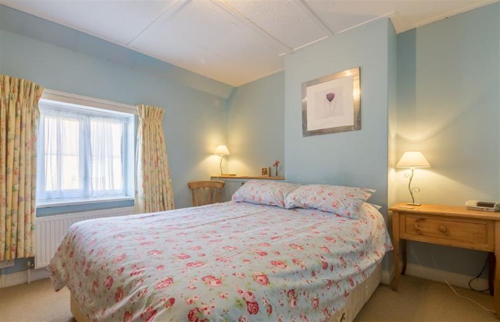 First floor: Master bedroom with double bed at Plunketts Cottage, Brancaster near Kings Lynn