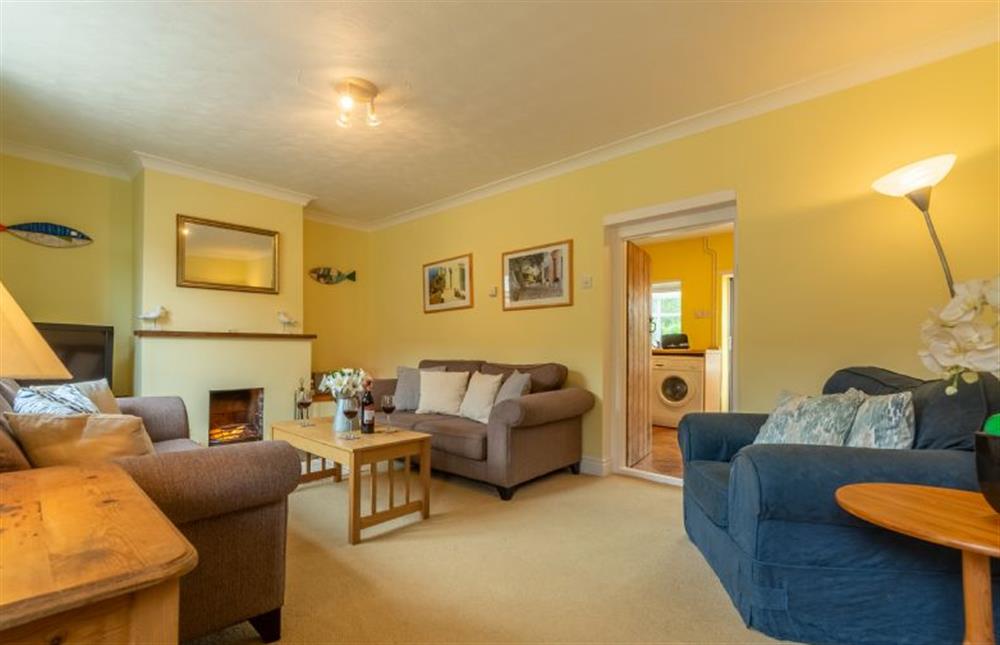 Ground floor: Sitting room has open fireplace at Plunketts Cottage, Brancaster near Kings Lynn
