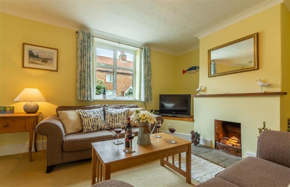 Ground floor: The comfortable Sitting room has open fire at Plunketts Cottage, Brancaster near Kings Lynn
