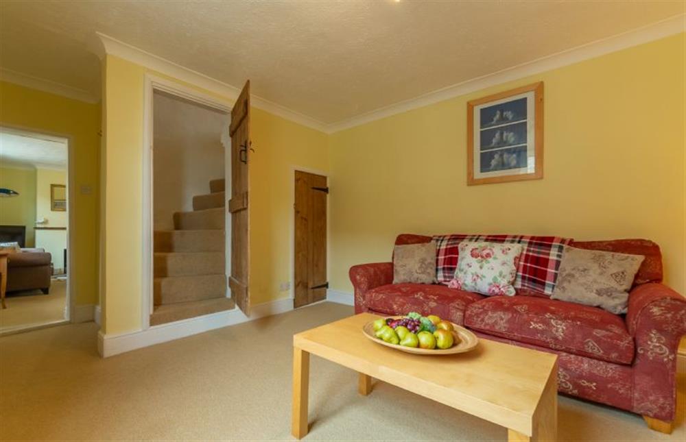 Ground floor: The Family room has Norfolk winder stairs to the first floor at Plunketts Cottage, Brancaster near Kings Lynn