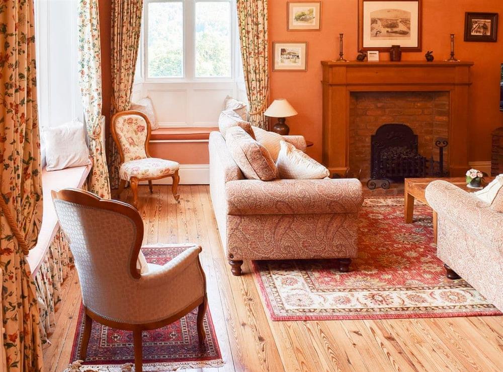 Sumptuous living room with open fireplace at Poets View Cottage in Ambleside, Cumbria