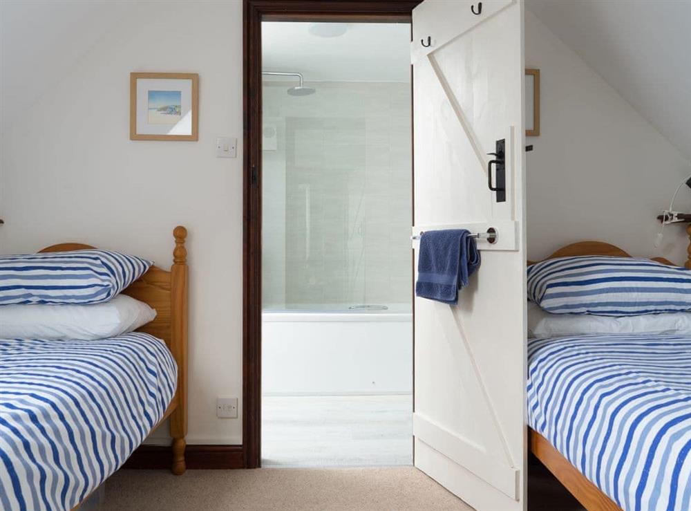 Twin bedroom with en-suite bathroom at Poirot Cottage in Lyme Regis, Dorset., Great Britain