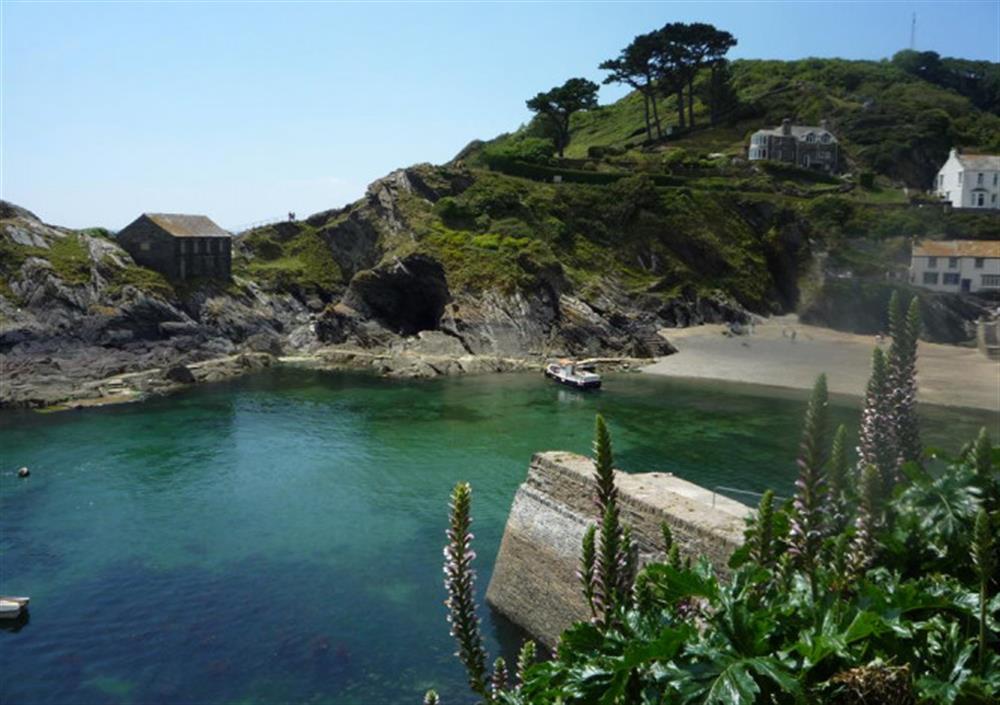 The little tidal beach and caves in the mouth of Polperro at Pol Glen in Polperro