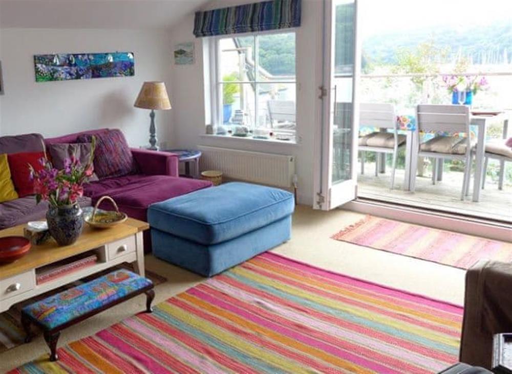Colourful sitting room with patio doors leading to the large balcony (photo 2) at Polbathic in Fowey, Cornwall