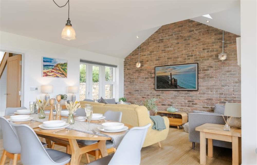 Dining area with a dining table seating up to eight guests at Polberro Cottage, St Agnes