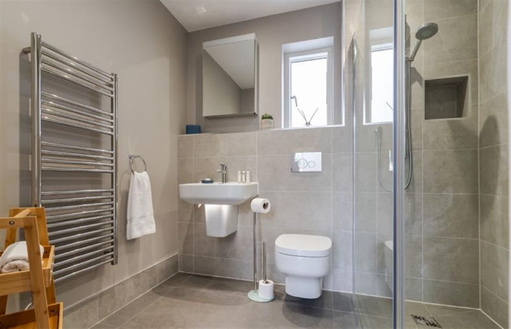 Family shower room with shower cubicle, wash basin, heated towel rail and WC at Polberro Cottage, St Agnes