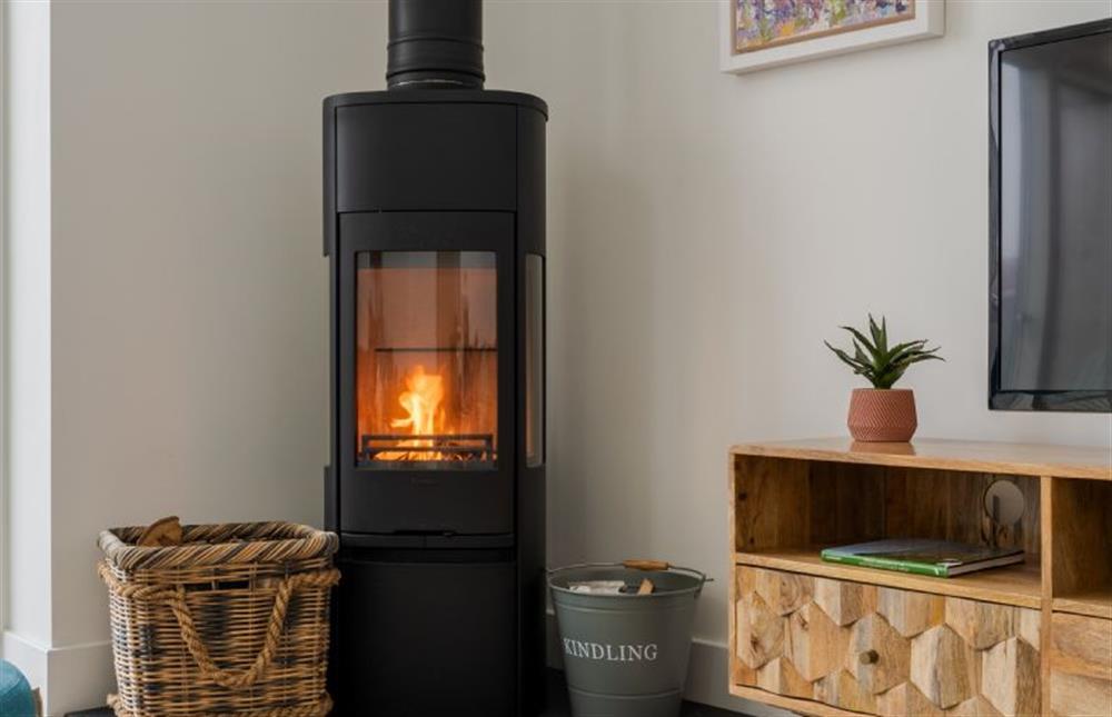 The contemporary wood-burning stove creates a cosy ambience. at Polberro Cottage, St Agnes
