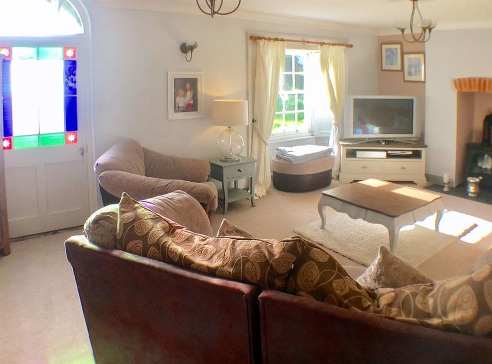 Comfortable living room with wood burner at The Old Farmhouse, 