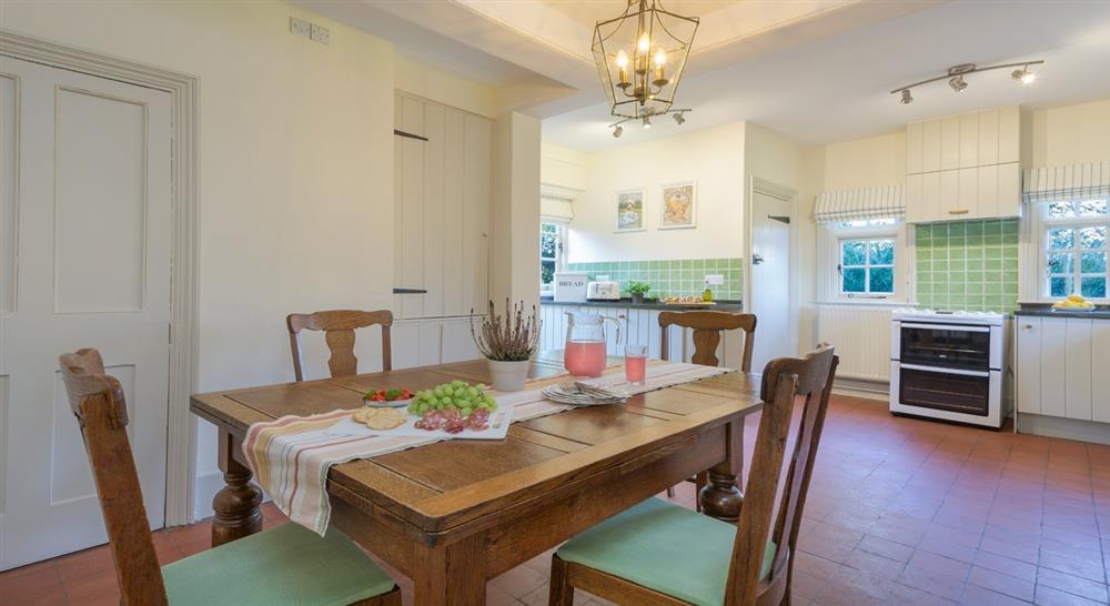 The kitchen and dining area at Polesden Garden Cottage in Bookham, Surrey