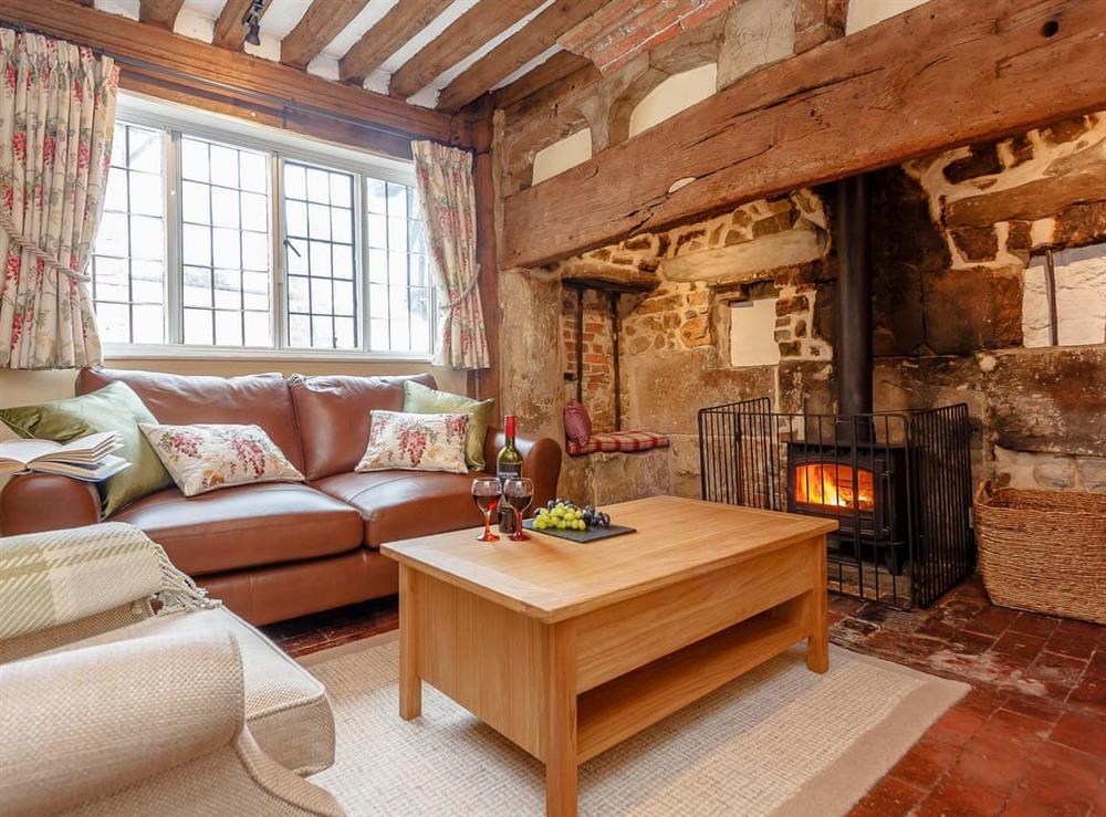 Living room with wood burner at Pollard Cottage in Lingfield, Surrey
