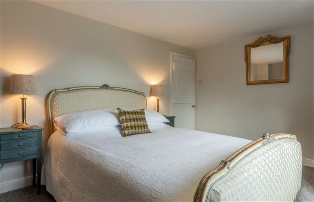 First floor: Master bedroom with a 19th century French 5ft king-size bed at Pond Cottage, Edgefield near Melton Constable