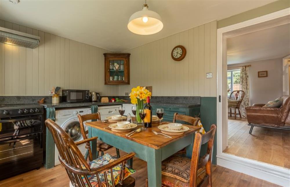 Ground floor: Kitchen/dining room with electric oven and hob, microwave, dishwasher, fridge,  washing machine and table with seating for four guests