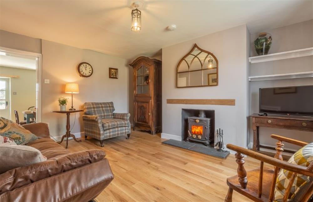 Ground floor: Sitting room with cosy wood burning stove at Pond Cottage, Edgefield near Melton Constable