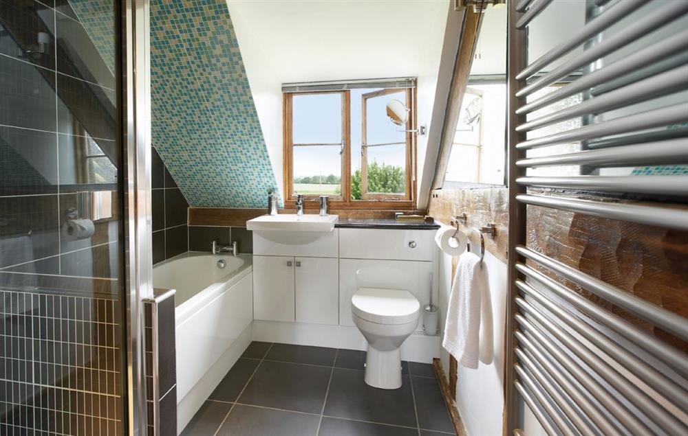 Family bathroom with bath and separate power shower at Pool Head Cottage, Westhide