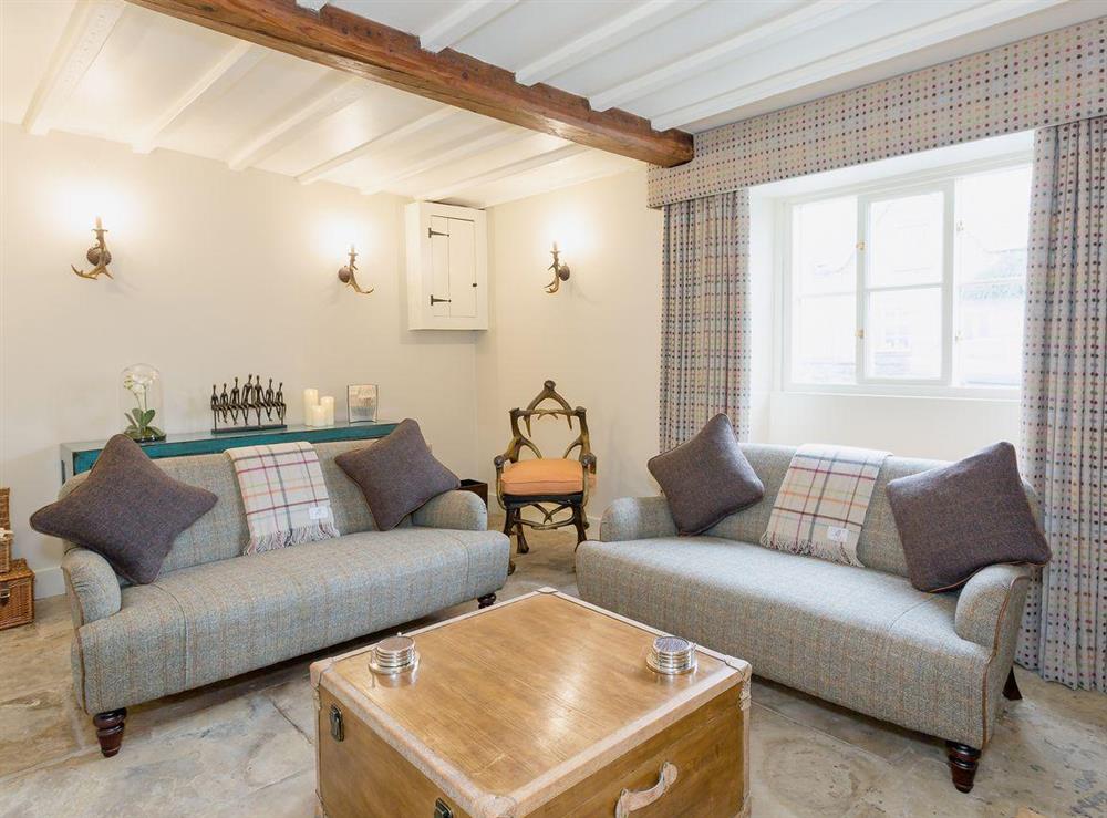 Comfortable sofas in the cosy living room at Poppy Cottage in Helmsley, North Yorkshire