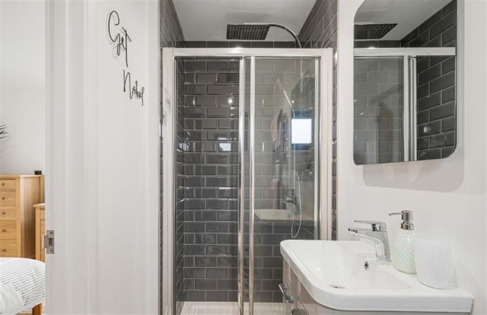 Bedroom two’s en-suite bathroom with over head shower, WC and wash basin at Poppyfields, Ashton