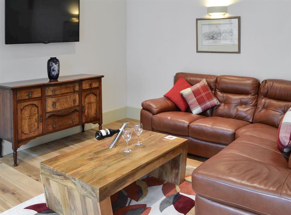 Living space with corner suite & LCD TV at Poppyfields Stable in Scorrier, near St Day, Cornwall