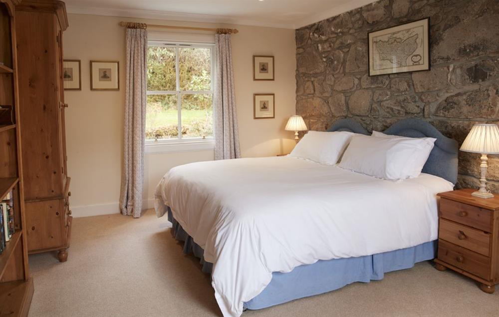 Bedroom with 6’ super king bed and adjoining bathroom with bath and handheld shower attachment at Port na Mine, Inverawe