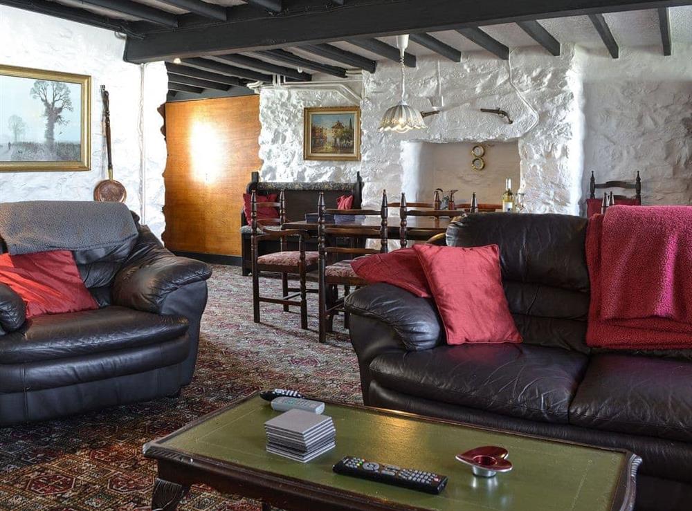 Living room with dining area at Porth Colmon Farmhouse in Porth Colmon, near Pwllheli, Gwynedd