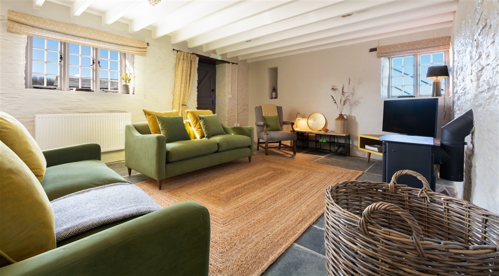 The open-plan sitting and dining room at Porth Mear Barn in Wadebridge, Cornwall